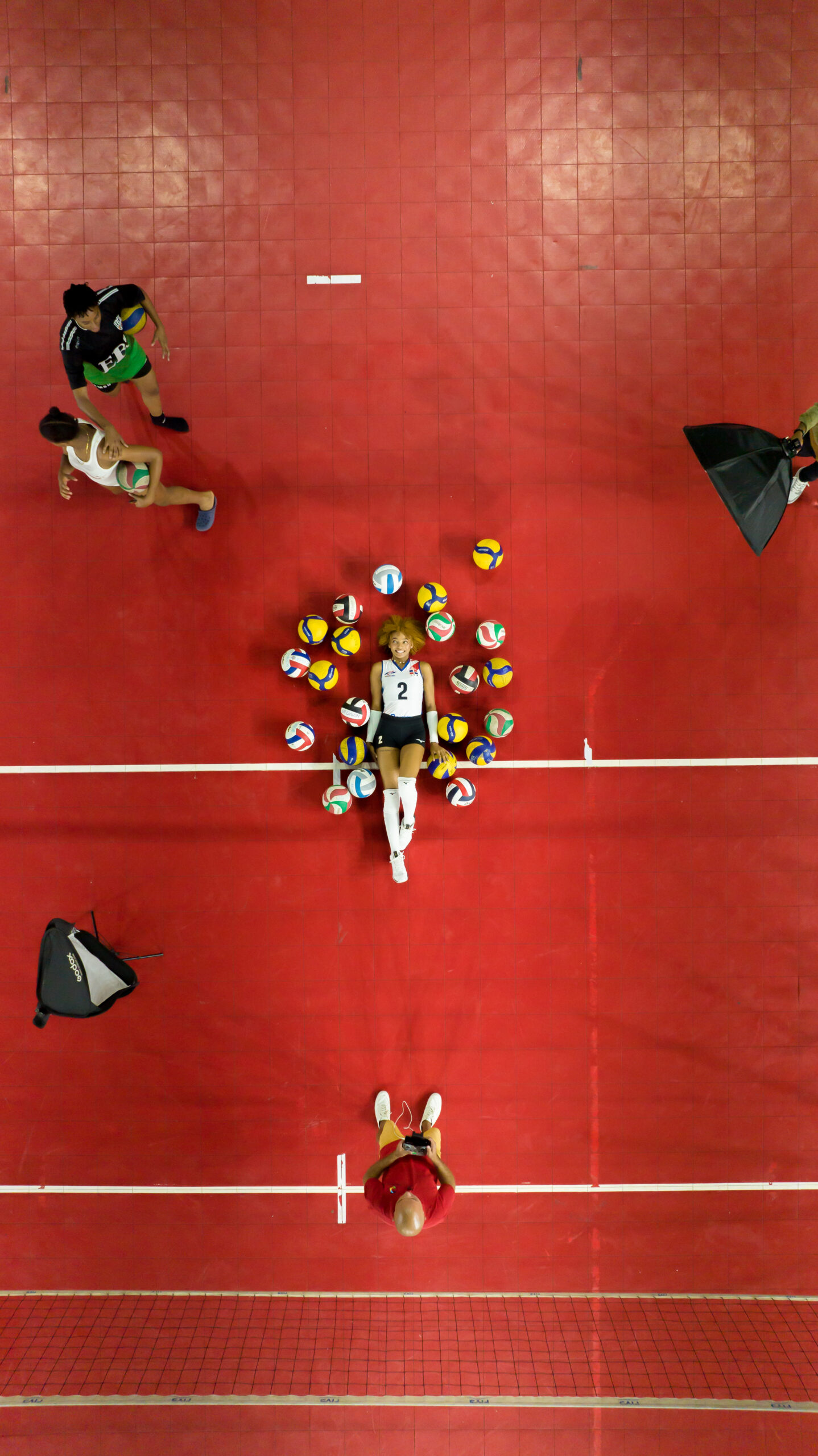 Fotografía de jugador de voleibol en remate nocturno con iluminación profesional en Santo Domingo.